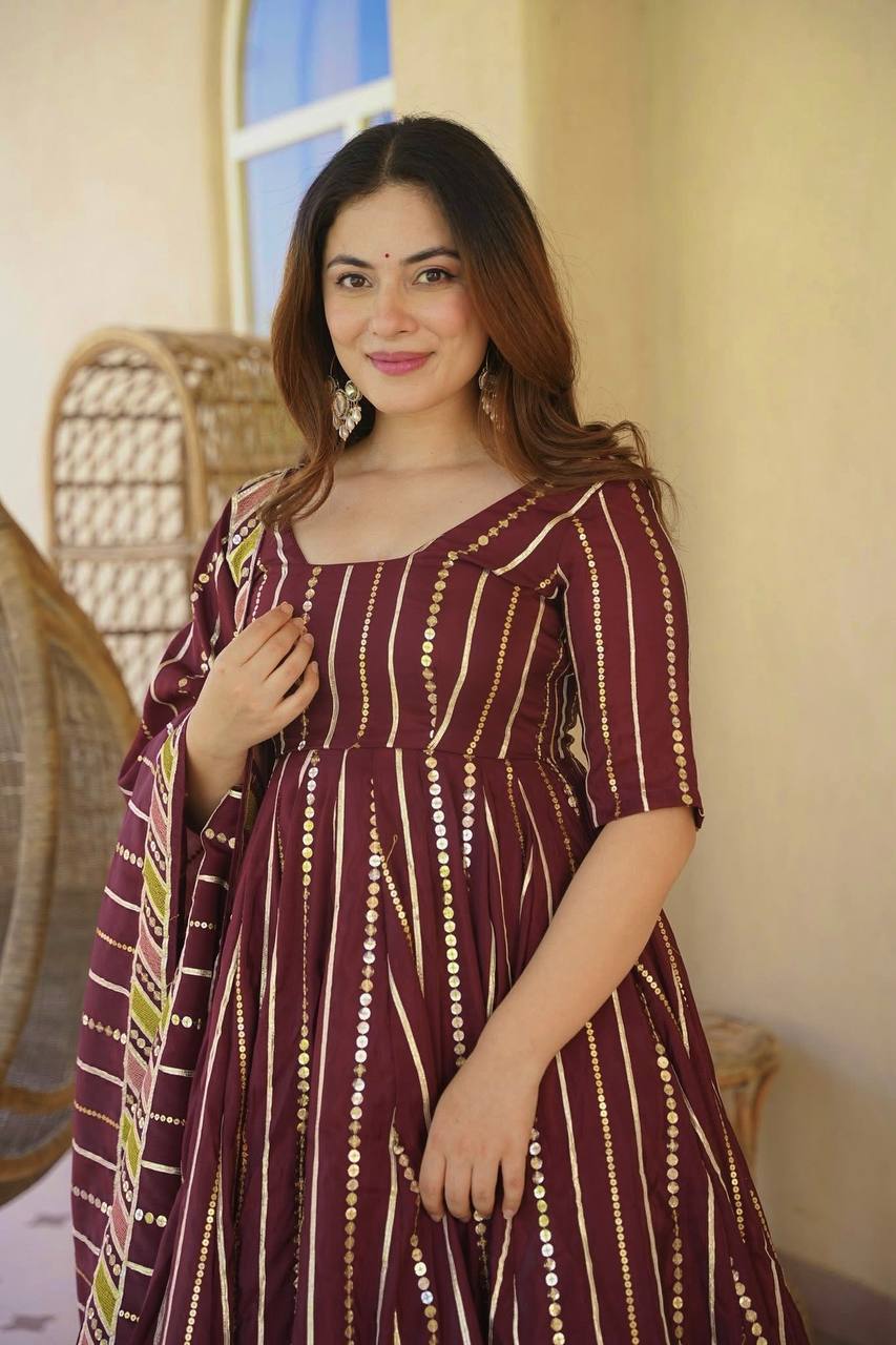 Majestic Maroon Flared Anarkali Suit Set Adorned with Luminous Sequin Stripes and an Ornate Floral Embroidered Hemline